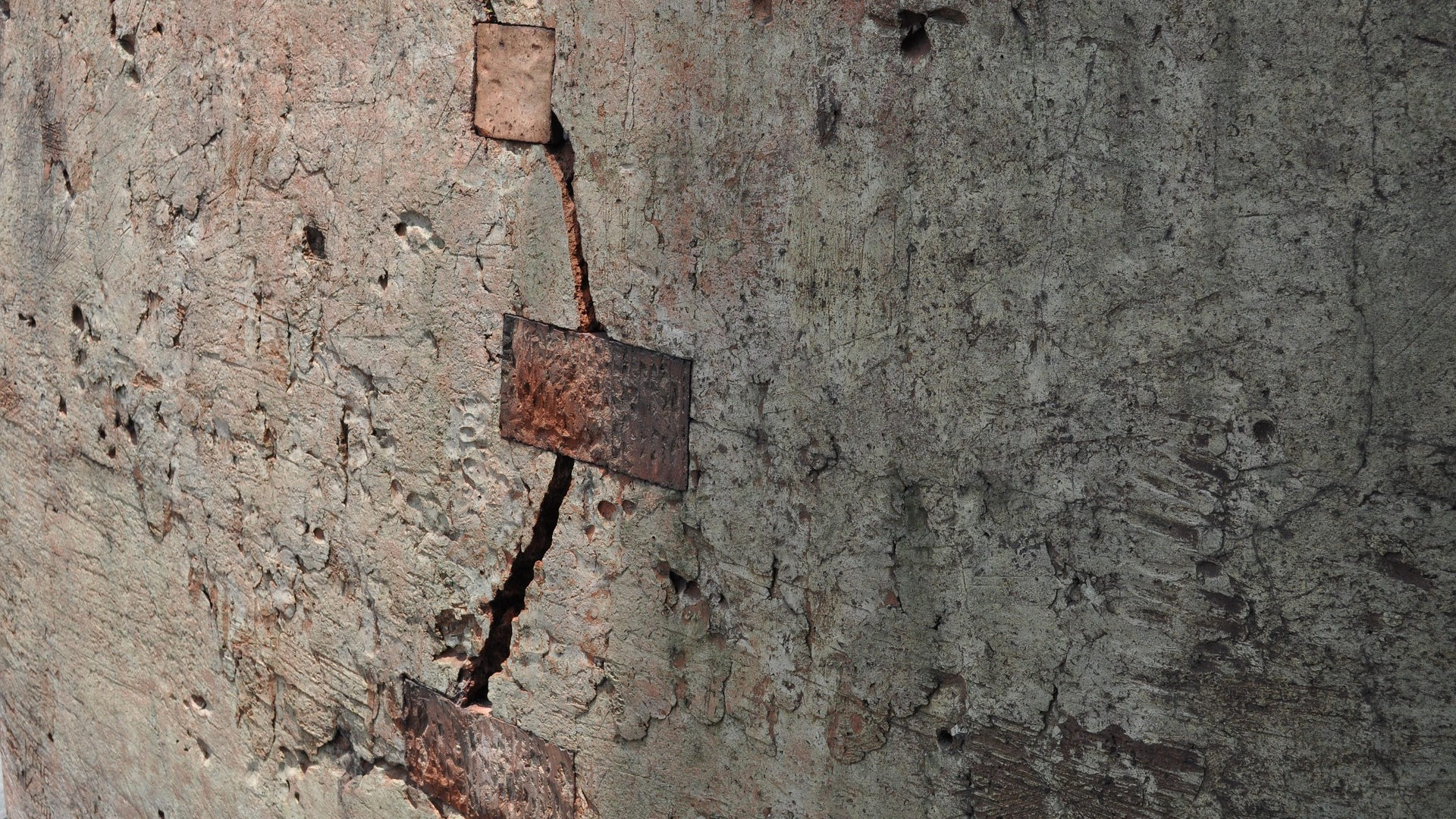 A stone wall with a patch